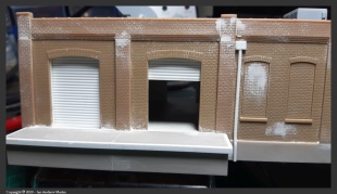 Some squadron white putty to clean up the major gaps in the parts also double as the remains of stucco, plaster or render, on the building. They'll be drybrushed during the weathering phase.